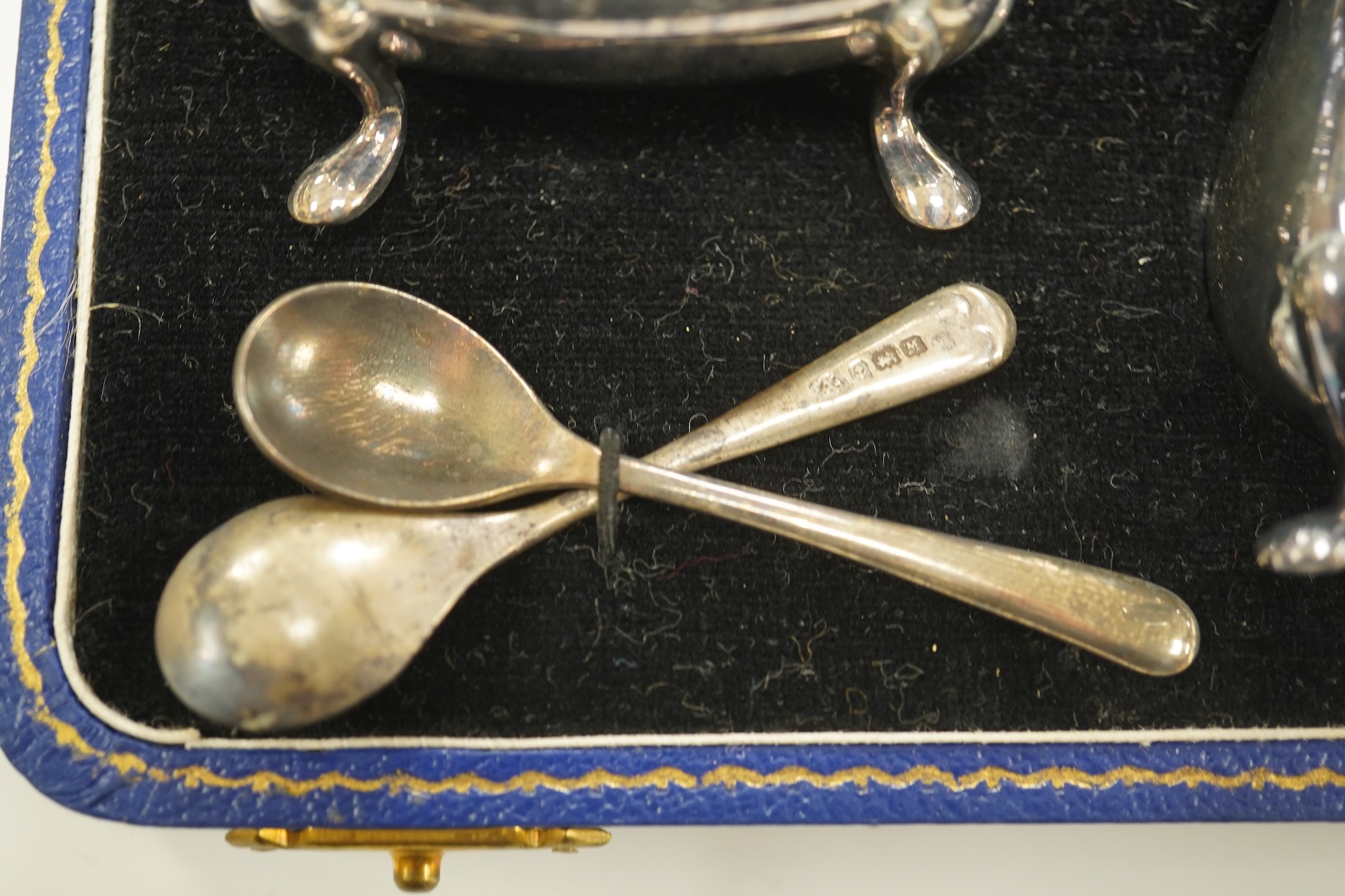 A cased 1960's three piece silver condiment set by William Suckling Ltd and and a cased pair of George III silver berry spoons, George Smith IV, London, 1812. Condition - fair